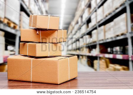 Stack Of Cardboard Boxes On Warehouse Background