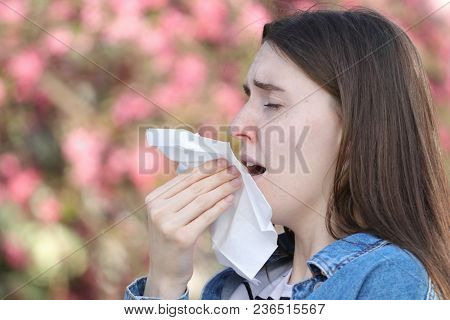 Teeneger Girl With  Flu Sneezing In Park