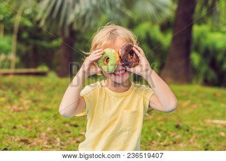 Funny Boy With Donut. Child Is Having Fun With Doughnut. Tasty Food For Kids. Happy Time Outdoor Wit