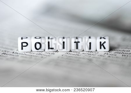 Grman Word Politik Formed By Wood Alphabet Blocks On Newspaper Closeup
