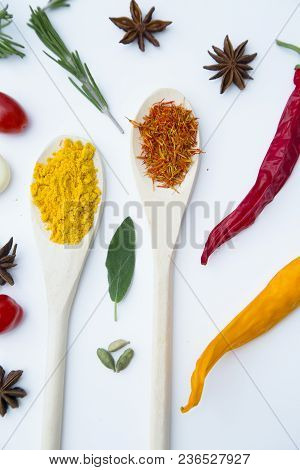 Cooking Hot Spicy Food Concept. Dry Spices And Herbs In Wooden Spoons And Chili Peppers, White Backg