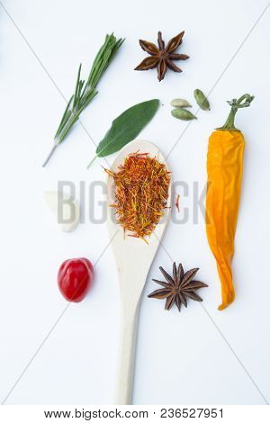 Cooking Hot Spicy Food Concept. Dry Spices And Herbs In Wooden Spoon And Chili Pepper, White Backgro