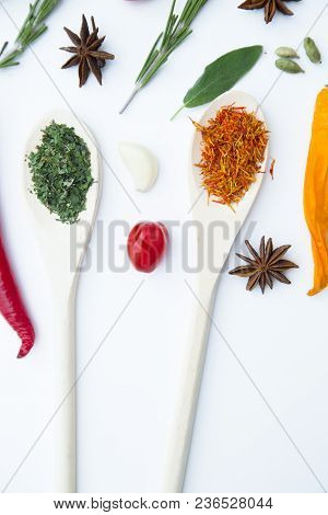 Cooking Hot Spicy Food Concept. Dry Spices And Herbs In Wooden Spoons, White Background, Top View, C
