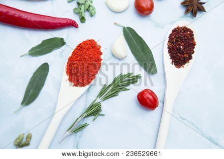 Cooking Hot Spicy Food Concept. Dry Spices And Herbs In Wooden Spoons, Fresh Herbs, Chili Peppers An