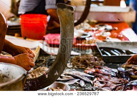Fisherman Cutting Fish On A Standing Blade Boti In Indian Fish Market At Kolkata