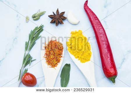 Cooking Hot Spicy Food Concept. Dry Spices And Herbs In Wooden Spoons, Fresh Herbs And Chili Peppers