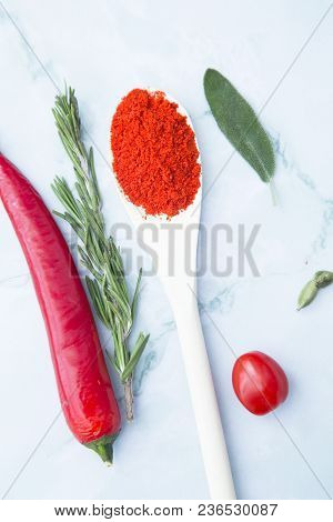 Cooking Hot Spicy Food Concept. Dry Spices In Wooden Spoon And Chili Pepper, White Marble Background