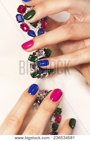 Fashionable Colorful Short Nail Art Design On Female Hand Close Up With Decoration On A Light Backgr