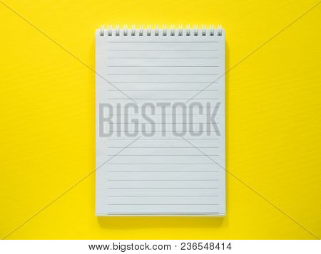 Notepad For Writing On The Yellow Desktop, Flat Lay, Copy Space.