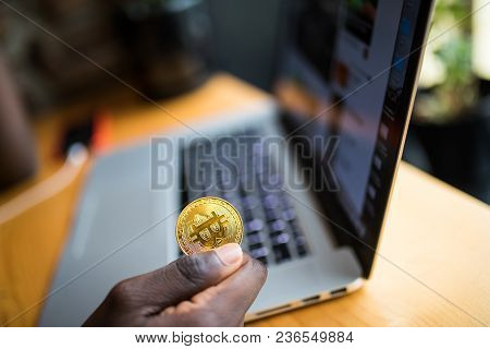 African Man Holding In Hand Symbol Of Bitcoin Crypto Currency - Electronic Virtual Money For Web Ban