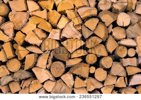 Material For Heating The House. Preparation Of Firewood For The Winter. Background Of Firewood. A Pi