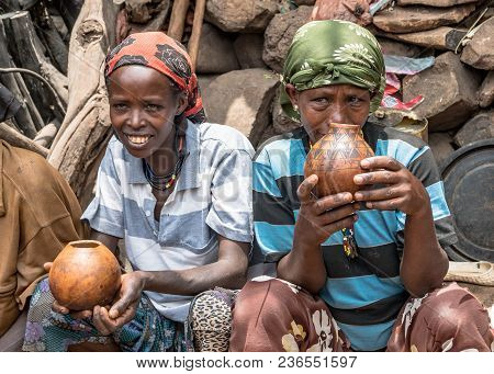 Omo, Ethiopia - September 2017: Unidentified Ethiopian Women Chatting And Drinking In Their Village.