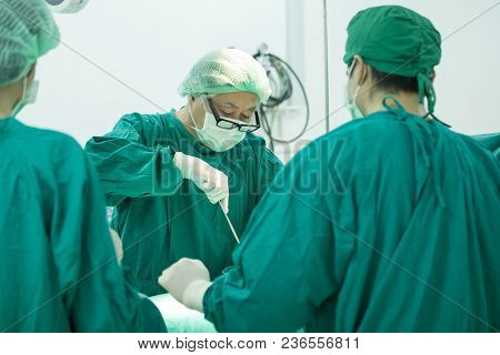 The Surgery Team Working Together At The Operating Room In The Hospital.