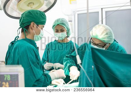 The Surgery Team Working Together At The Operating Room In The Hospital.
