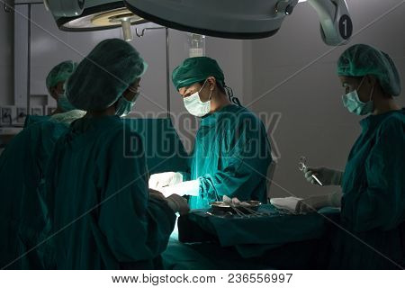 The Surgery Team Working Together At The Operating Room In The Hospital.