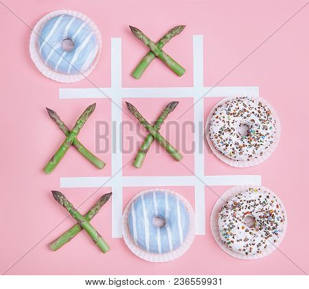 Tik Tak Toe Game With Donuts And Asparagus. Health Nutrition Concept Image