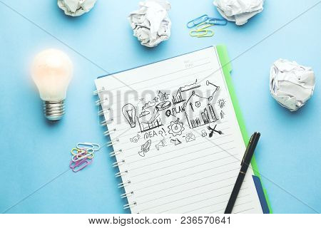 Idea Wiith Plan On Noteook On Blue Background