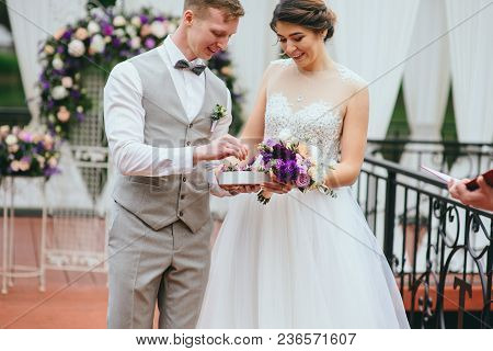 Bride And Groom Exchange Rings At The Wedding