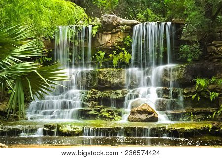 A Waterfall In The Prehistoric Park At Zilker Botanical Garden In Austin, Texas