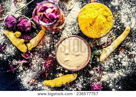 Ayurvedic Ubtan Of Turmeric/haldi And Mulpani Mitti Or Fuller’s Earth With Rose Water On A Black Sur