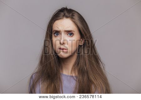 Offended Stressful Female Bites Lower Lip With Dissatisfaction, Has Sorrorful Expression, Expresses 