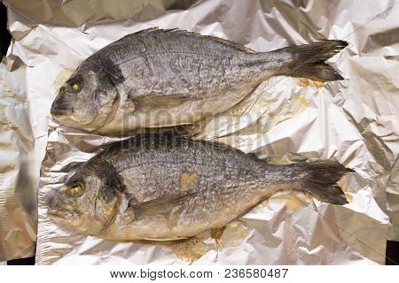 Two Grilled Whole Dorado Fish Cooked On Foil