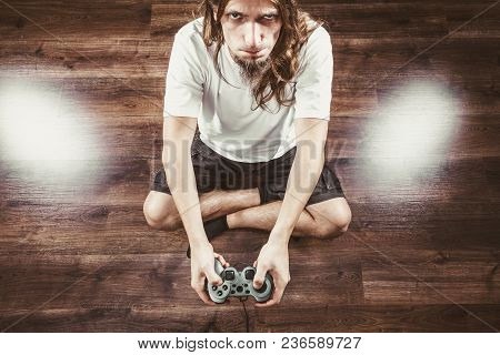 Addiction Effects Concept. Young Unhappy Depressed Man With Pad Joystick Playing Games. Male Addicte