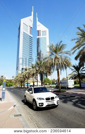 Dubai, Uae - November 19: The Emirates Towers And Bmw X6 Suv On November 19, 2017. The Emirates Towe