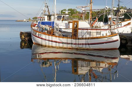 Grisslehamn, Sweden - Jul 08, 2017: Traditional Fishing Boat Reflecting In The Water In The Small Ha