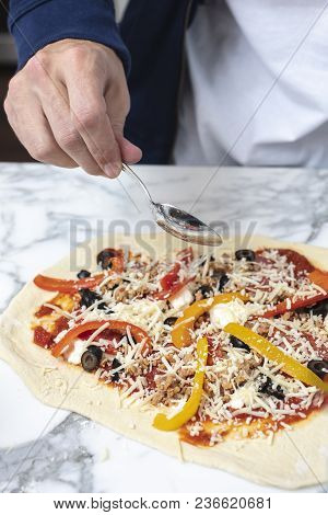 Man Pointing At Homemade Pizza Before Baking In The Oven
