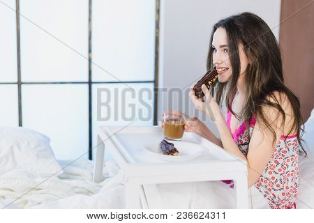 Girl With A Cake In The Bed Drinking Coffee On The Window Background