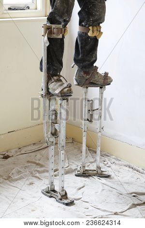 Plasterer On Stilts Plastering A High Ceiling