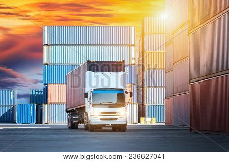 Truck With Cargo Container On Road In Shipping Yard