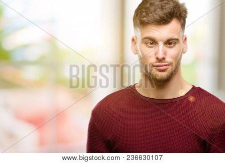 Handsome young man making funny face fooling