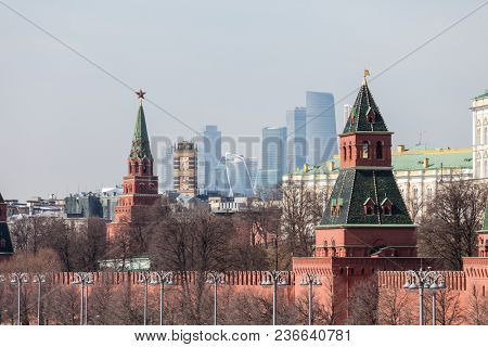 MOSCOW, RUSSIA - APRIL 5, 2018: Famous Russian historical Grand Kremlin Palace, Walls and Towers in front of modern Moscow International Business Center (MIBC) skyscrapers at Moscow City.