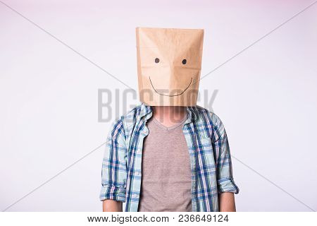 Unknown Man With A Paper Bag On His Head On White Background.