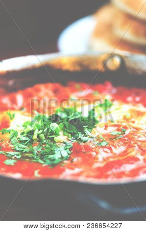 Shakshuka. Traditional Jewish Food And Middle Eastern Cuisine Recipe. Fried Eggs, Tomatoes, Bell Pep