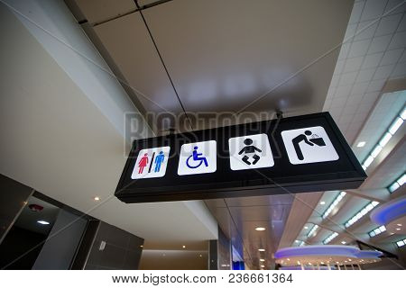 A Black Toilet Sign At The Airport