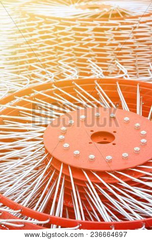New Red Tedder For Trailer In Agricultural Machinery For Gathering Hay. Close Up