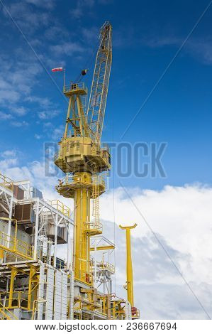 Oil And Gas Central Processing Platform, Construction Crane Loading Cargo Between Platform And Suppl