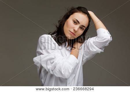 Beautiful Girl In A White Shirt Shows Emotions. On A Light Background.
