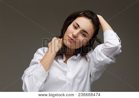 Beautiful Girl In A White Shirt Shows Emotions. On A Light Background.
