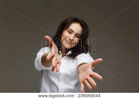 Beautiful Girl In A White Shirt Shows Emotions. On A Light Background.