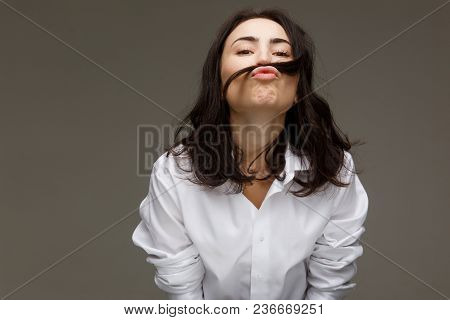 Beautiful Girl In A White Shirt Shows Emotions - Smile, Fun. On A Light Background.