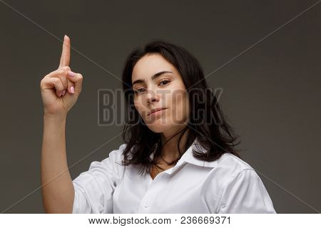 Beautiful Girl In A White Shirt Shows Emotions. On A Light Background.