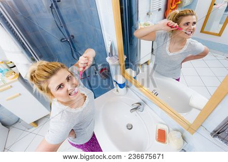 Woman Brushing Cleaning Teeth Closeup. Funny Blonde Girl With Toothbrush In Bathroom. Oral Hygiene. 