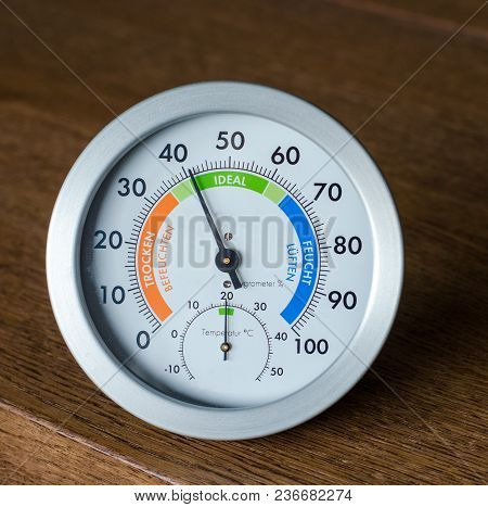 Close-up Of Hydrometer And Thermometer On Wooden Background