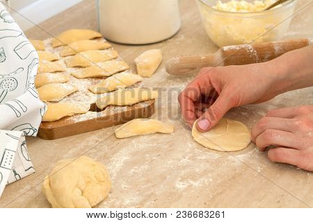 Douhg Preparation For Cooking Dumplings. Womens Hand Cutting Up Dough. Womens Hands In A Process Of 