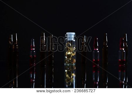 Pill Bottle And Pills In Isolated On Black Concept Pharmacy. With Copy Space.