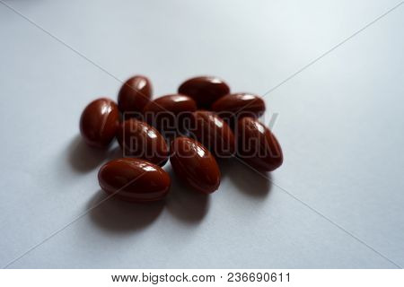 Fistful Of Red Capsules Of Lutein Dietary Supplement